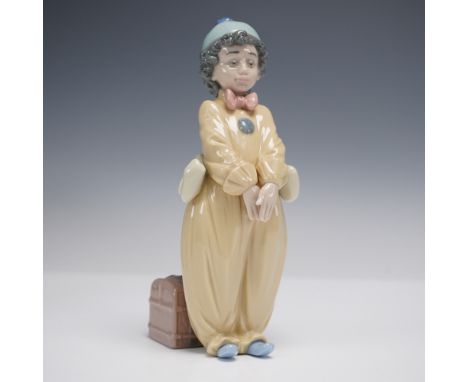 Charming Lladro porcelain figurine featuring Pierrot in a soft yellow costume with blue shoes and a pastel blue cap. The figu