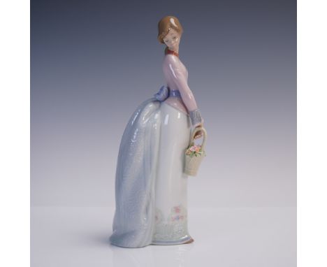 Delicately modeled by sculptor Jose Puche, "Basket of Love" is a graceful Lladro porcelain figurine issued in 1994 as an excl