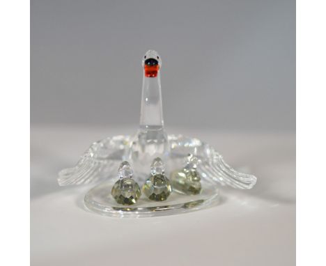This exquisite Swarovski crystal figurine, part of the "Beauties of the Lake" collection, features a graceful swan family. De