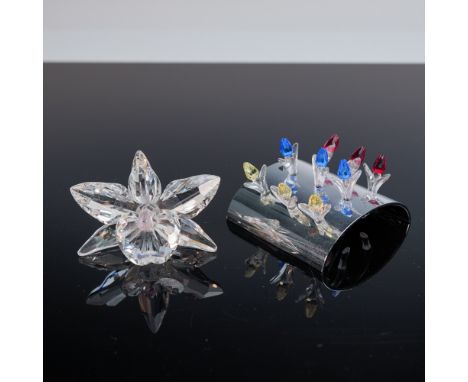 A two-piece Swarovski crystal lot including the 2002"2004 Renewal Gift: a set of nine mini tulips in red, blue, and yellow cr