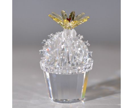 A beautifully crafted Swarovski crystal figurine featuring a faceted clear crystal cactus adorned with a stunning golden-yell