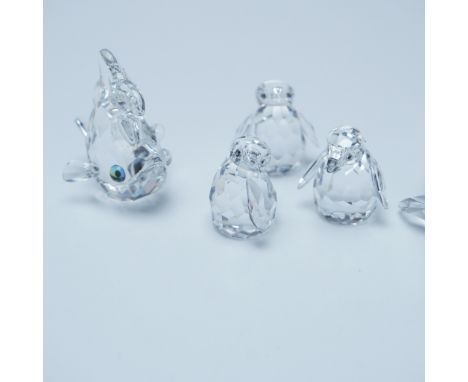 This Swarovski crystal collection features a variety of aquatic and Antarctic-themed figurines. The set includes three baby p