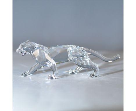 Exquisite Swarovski crystal figurine depicting a stalking leopard in a poised and elegant stance. Crafted from clear faceted 