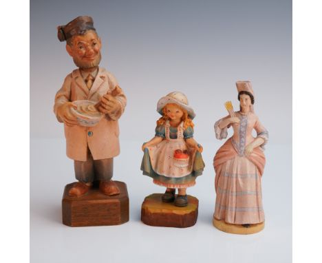 A finely detailed trio of hand carved and painted Anri wooden figurines, each full of charm and personality. Included is a ch
