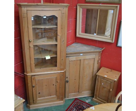 A pine floor standing corner display cabinet; another, wall hanging; a bedside/pot cupboard; a wall mirror (4)