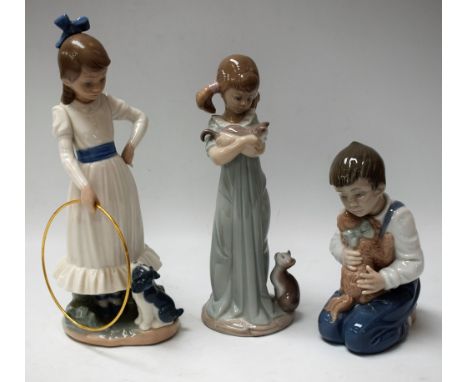 A Lladro figure, Girl with Kittens; others Nao, Girl with Puppy and Hoop; Boy with Puppy, printed marks (3)