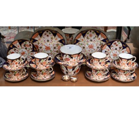 A Royal Crown Derby Imari part tea service, printed marks, comprising cups, saucers, side plates, slop bowl, sugar bowl, brea