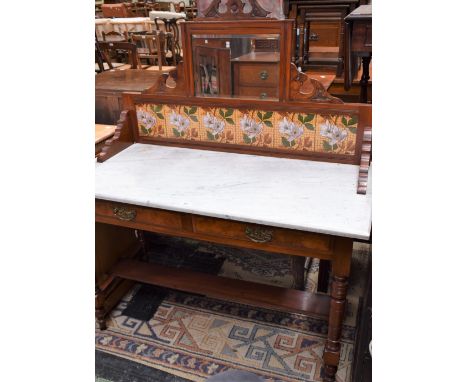 An Art Nouveau washstand, the shaped superstructure crested by a rectangular mirror above a tile back, the base with a rectan
