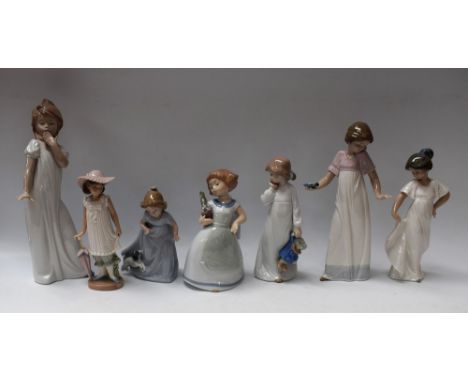 A Nao figure, of a young girl in a nightdress; another, girl with puppy; others, similar, Parasol, etc (7)