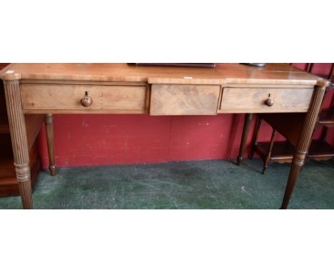 A George III style buffet/serving table, hipped slightly breakcentre rectangular top with brass gallery above three frieze dr