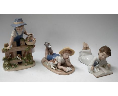 A Nadal Spanish porcelain figure, Boy at Gate with Puppy; another, Boy Reading with Puppy, printed marks; a Nao figure simila