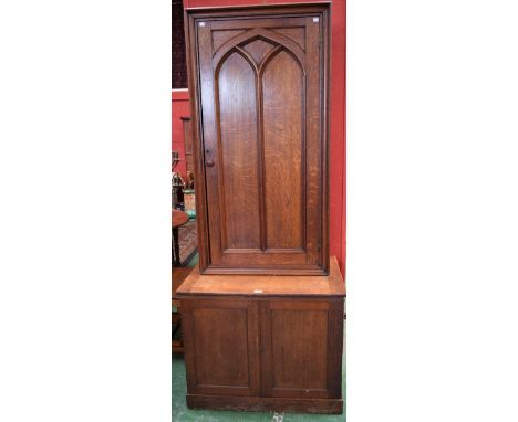 A Victorian Gothic Revival oak book cabinet, architecturally moulded and applied door enclosing an arrangement of shelves, th