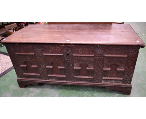 A substantial late 17th/early 18th century oak chest/coffer, hinged rectangular top enclosing a till, the front carved and ap