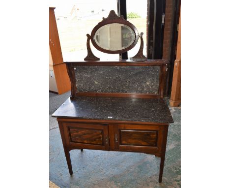 An Art Nouveau style washstand, the shaped superstructure crested by an oval mirror and marble splashback, the base with a re