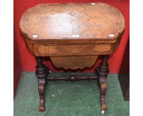 A Victorian walnut games/work table, hinged shaped rectangular top enclosing surfaces for chess and backgammon above a single