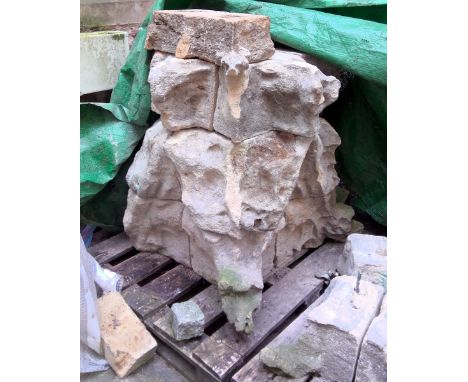 Stones forming the base of a pinnacle, with a gablet and finial on each of the four faces, each gablet with a pair of grotesq