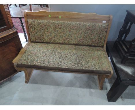 A golden oak waiting room style bench seat