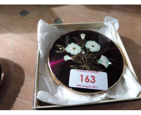 A boxed Stratton compact with enamel floral decoration
