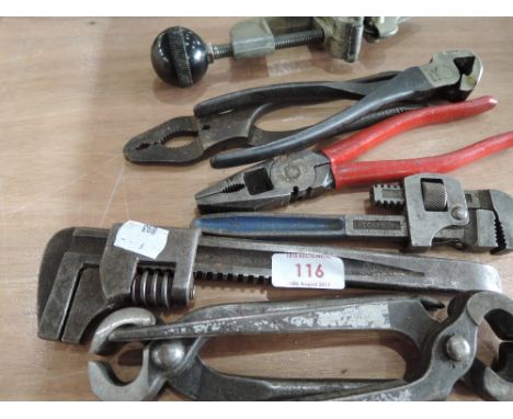 A selection of vintage tools including pipe cutter, pliers and adjustable wrenches