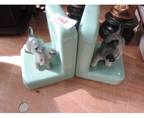 A pair of ceramic bookends with kitten decoration