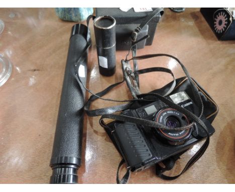 A Cannon Sureshot camera, Kodak Instamatic camera, telescope and boxed small telescope