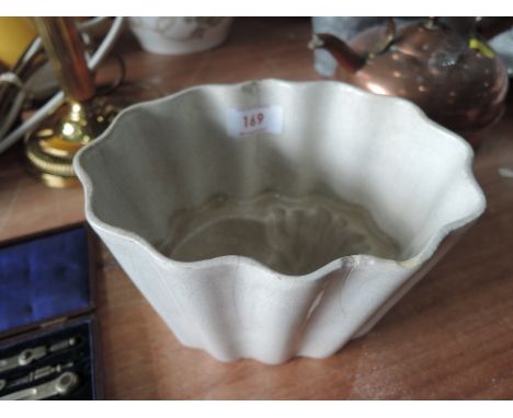 A vintage ceramic jelly mould of sleeping lion