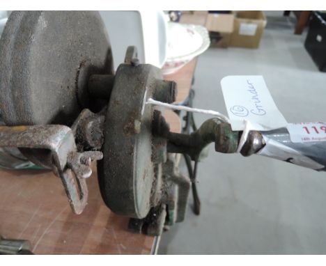 A bench mounted hand turned grinder 