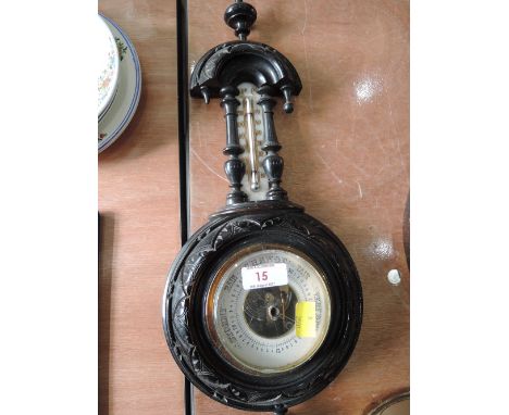 A carved Black Forrest style German barometer stamped 965