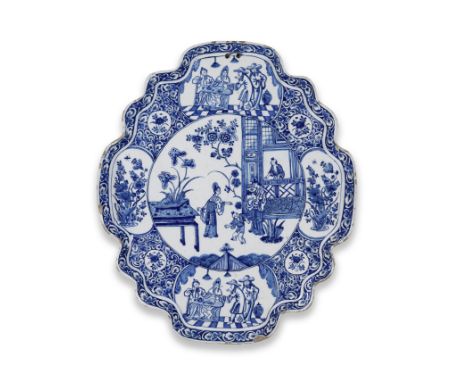 A large Dutch Delftware plaque, circa 1740-60The shaped oval cartouche with four medallions depicting two men standing beside