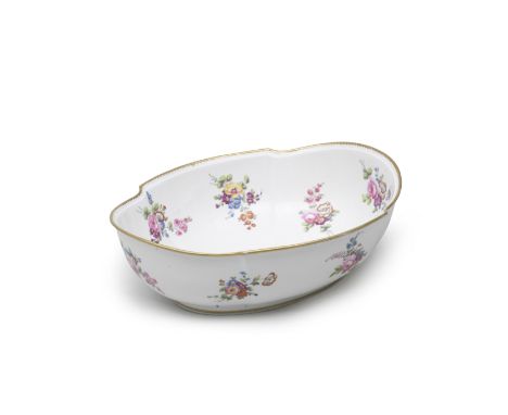 A Sèvres large hard-paste porcelain basin (jatte ovale), circa 1785Painted with scattered flower sprays, a gilt dentil border