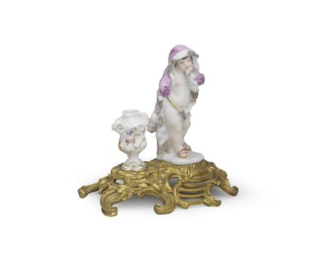 An ormolu-mounted figure of a Meissen putto emblematic of Winter, mid 18th centuryThe putto wearing a fur-lined pink cloak em