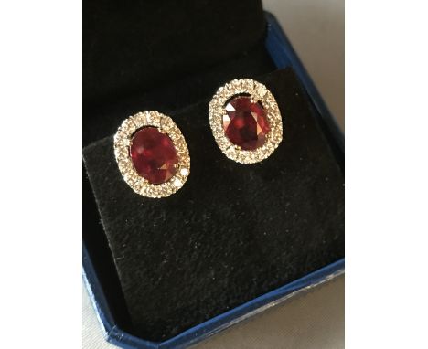 Pair of 18 carat yellow gold, ruby and diamond earrings, 6.3 carats total weight