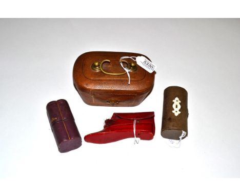 A Victorian Brown Leather Sewing Companion lined in mauve silk and fitted in the lid for various ivory tools, the base compar