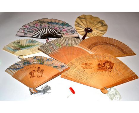 A Selection of Interesting 20th Century Chinese and Japanese Fans, starting with a wood example with simple bands of piercing