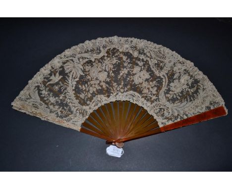 A Fine Quality and Large Brussels Point De Gaze Needle Lace Fan of unusual design, with a bird in flight approaching a palm t