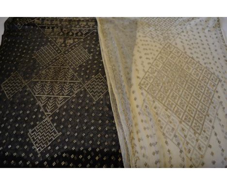 Two Art Deco Azute or Assyut Shawls, from circa 1925: the first, in black cotton, with silver metal strip decoration is desig