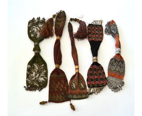 Five Purse Examples, to include three heavily beaded miser's or stocking purses, the first with a sage green ground, the two 