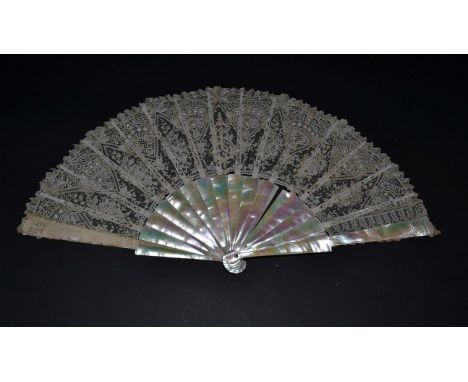 A Good Late 19th Century Brussels Needle Lace Fan Leaf with geometric design, mounted on mother-of-pearl ribs, on green/pink 