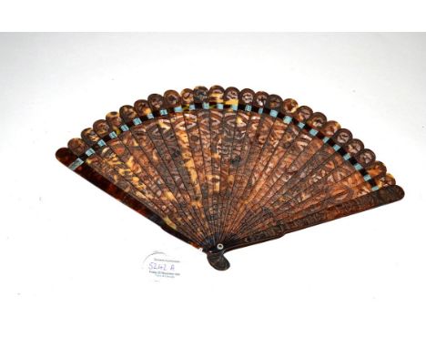 A Fine and Slender 19th Century Chinese Carved Tortoiseshell Brisé Fan, the intricate design covering the 24 inner sticks and