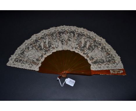 A Late 19th Century Brussels Lace Fan, the Point de Gaze needle lace leaf mounted on resin or ''blonde tortoiseshell'', The u