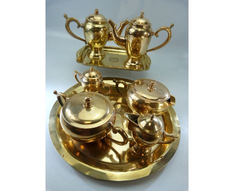 Metalware: A tea and coffee service on two trays consisting of coffee pot and water pot on one tray and tea pot sugar bowl, m