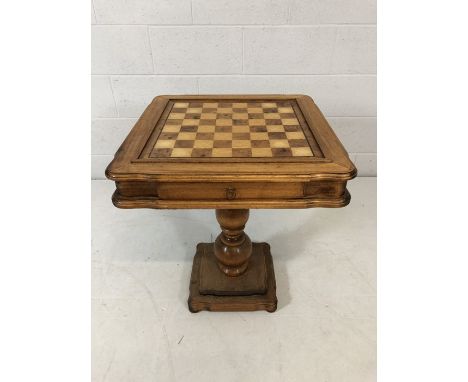 Light wood Chess table on turned pedestal base with drawer containing Chess pieces 