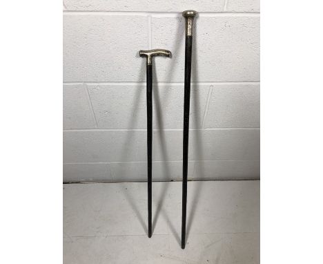 Two ebony silver-topped walking canes, hallmarked Birmingham and London, one dated 1894, the other with inscribed design