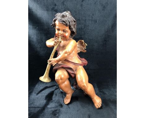A Painted architectural style Cherub with characteristic Trumpet 