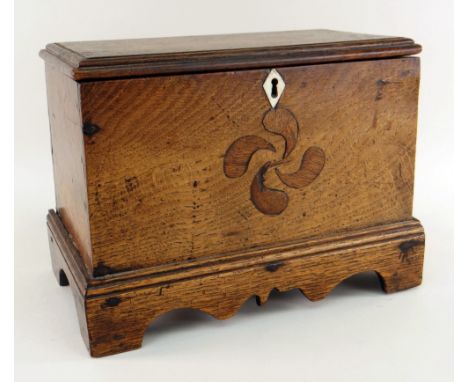WELSH JOINED OAK MINIATURE COFFER having a stepped base with carved apron and bracket feet, detachable moulded lid, the front