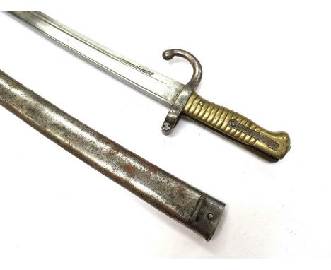 A model 1866 French Sabre bayonet, dated 1873 and inscribed, with scabbard 