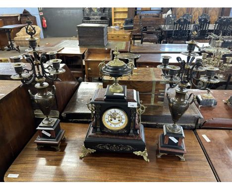 Late 19th Century French black slate and marble clock garniture, the central clock with urn formed mount, a white enamel dial