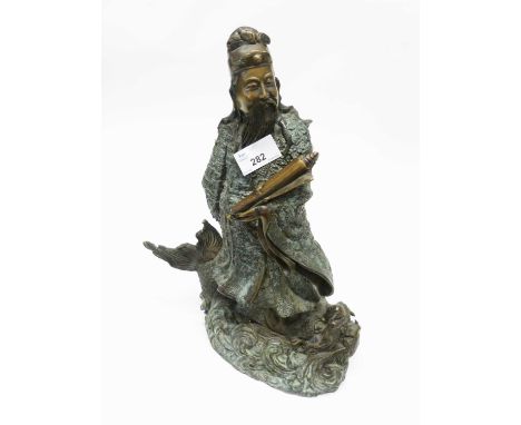 A large bronzed model of a Chinese Deity holding a scroll on scroll base, 40cm high