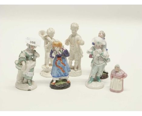 A group of continental porcelain figurines mainly of children together with a early 20th Century Royal Worcester candle snuff