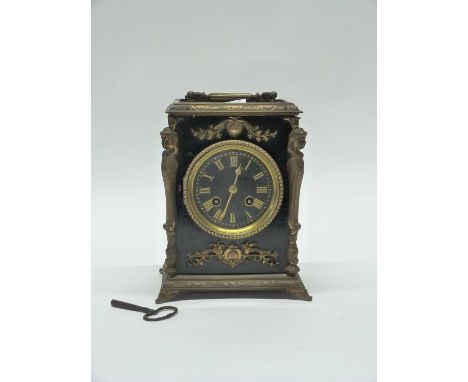 A 19th Century brass mantel clock,  black ebonised wood with gilt brass decoration, 23cm high (with key)